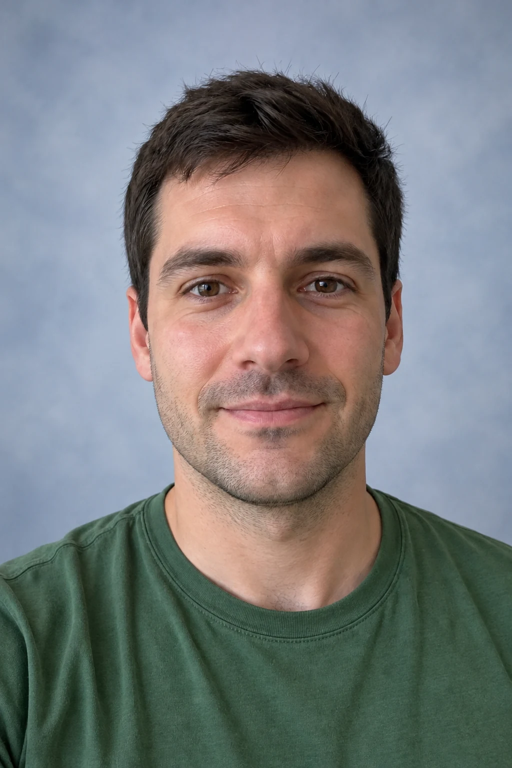Portrait with natural light against a blue-gray backdrop